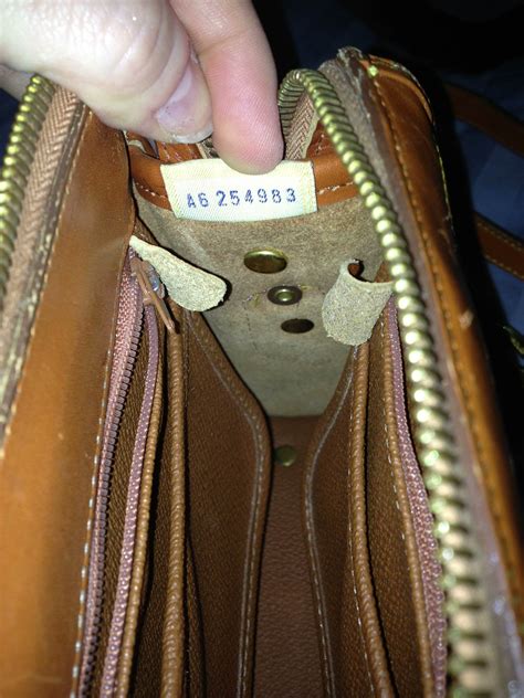 dooney and bourke wristet real or fake leather tag